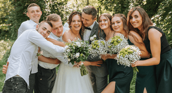 a bride and groom surrounded by their bridesmaids and groomsmen